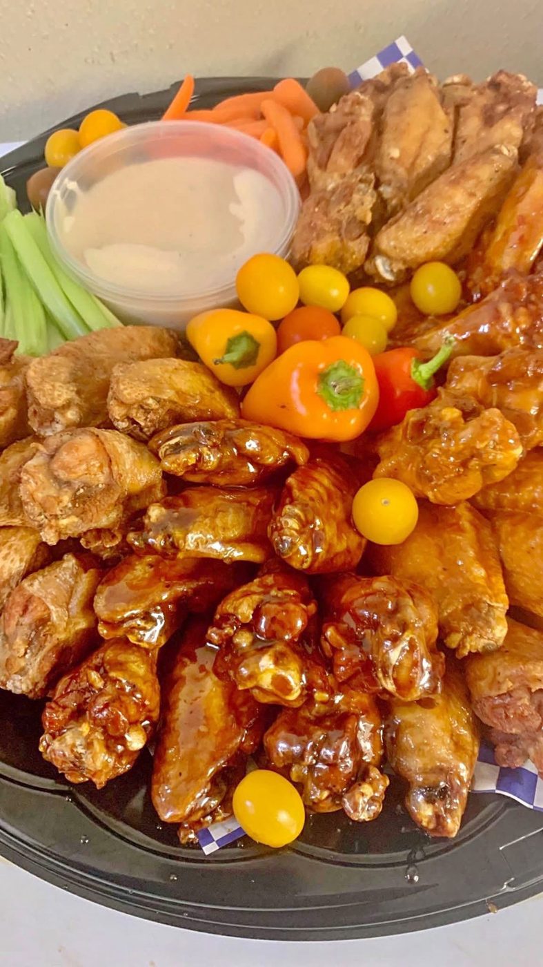 Wing platter with celery, carrots, peppers, and dipping sauce